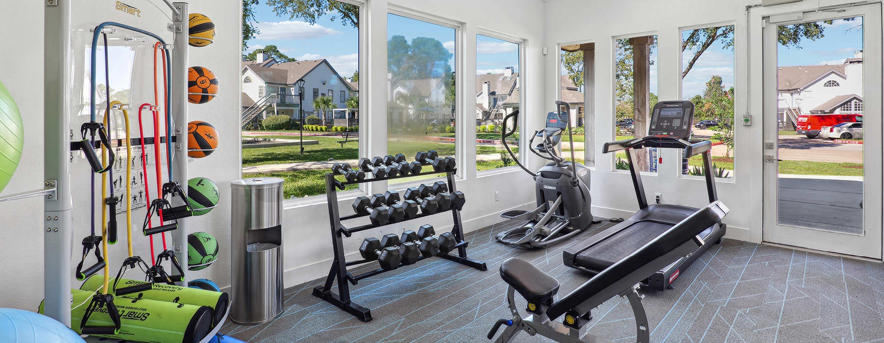 sun-filled gym with exercise equipment