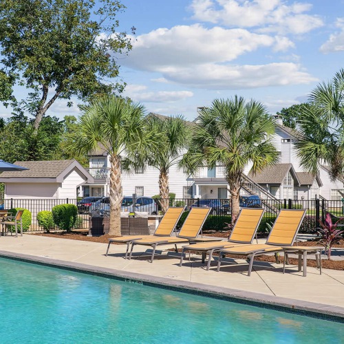 Resort-style swimming pool poolside lounge chairs